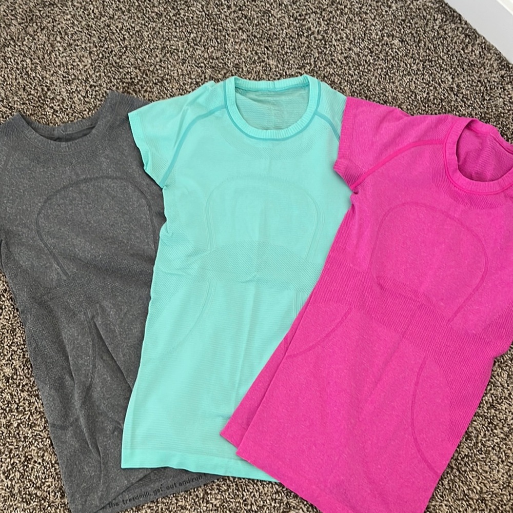 Three Lululemon Athletica workout T-shirts. Size 4. Like new.